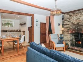 A living room with a sofa and table at Tiller Cottage in Dartmouth