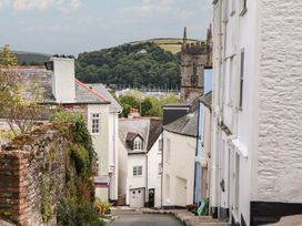 A street view featuring houses and a church in Dartmouth