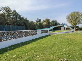 A water slide and grass area at Beech Lodge in Wadebridge