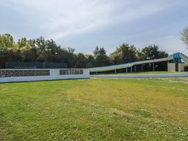 An outdoor space with a water slide and grass at Beech Lodge in Wadebridge