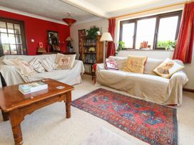 A living room with sofas and a wooden table at Dunvant in Swanage