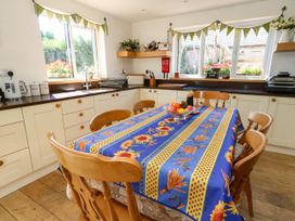 A kitchen with a table and fruit bowl at Dunvant in Swanage