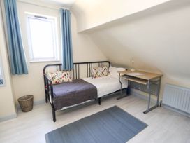 A bedroom with a bed and desk at Dunvant in Swanage
