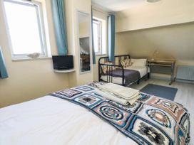 A bedroom with a double bed and a single bed at Dunvant in Swanage