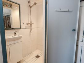 A bathroom with a shower and sink at Dunvant in Swanage