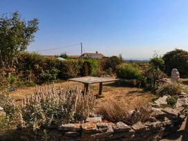 A garden with a table surrounded by plants at Dunvant in Swanage