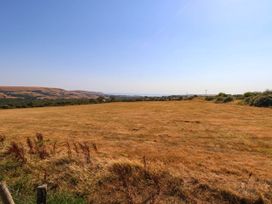 A field with hills and a clear sky at Dunvant, Swanage