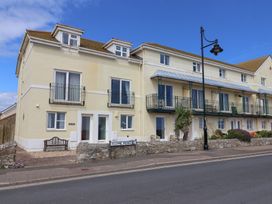 A house with balconies and a street sign at 2 Lyme Mews in Seaton