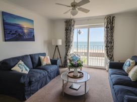 A living room with sofas and a coffee table at 2 Lyme Mews in Seaton