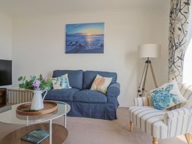 A living room with a sofa and coffee table at 2 Lyme Mews Seaton