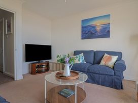 A living room with a sofa and television at 2 Lyme Mews Seaton