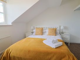 A bedroom with a bed and bedside table at 2 Lyme Mews Seaton