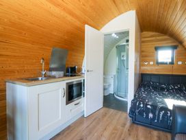 A pod with kitchen, shower, toilet and bed at Bron Eifion Pod 2 Criccieth