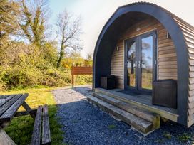 An outdoor view of a pod with steps and surrounding greenery at Bron Eifion Pod 2 Criccieth