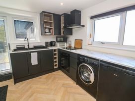 A kitchen with appliances and cabinets at The Annex in Penzance