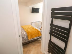 A bedroom with a bed and a TV at The Annex in Penzance