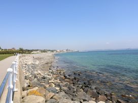 A pathway along the shore with rocks and sea at The Annex in Penzance
