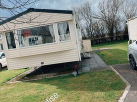 A mobile home with windows and steps in an outdoor area at Skipsea sands holiday park Driffield