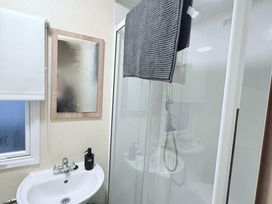 A bathroom with a sink and shower at Skipsea sands holiday park in Driffield