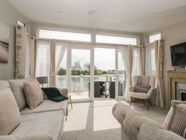 A living room with a view of the water at Swan Haven in Grange-Over-Sands