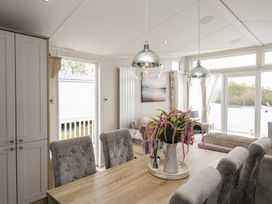 A dining area with a table and chairs at Swan Haven in Grange-Over-Sands