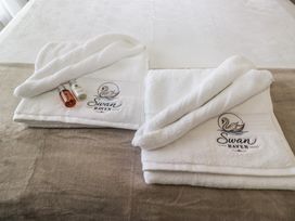 Towels and toiletries arranged on a bed at Swan Haven in Grange-Over-Sands