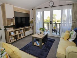 A living room with a TV and coffee table at Santa Maria in Llandysul