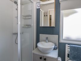 A bathroom with a shower and sink at Santa Maria in Llandysul