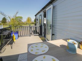 An outdoor seating area with a table and chairs at Santa Maria in Llandysul