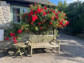 A bench and table near flowers at Starling Cottage near Cowbridge