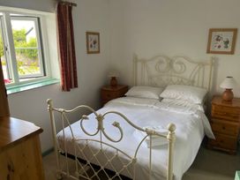 A bedroom with a bed and bedside tables at Starling Cottage near Cowbridge