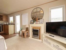 A living room with a television and fireplace at CC2