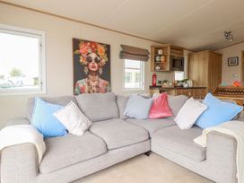 A living room with a sofa and wall art at CC2