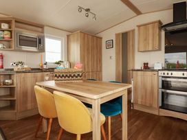 A kitchen with a microwave and dining table at CC2