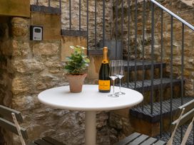 A table with champagne and glasses in an outdoor area at Church Alley House Stow-On-The-Wold