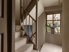 A hallway with stairs and a window at Church Alley House in Stow-On-The-Wold