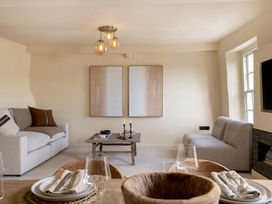 A living room with a sofa and table at Church Alley House Stow-On-The-Wold