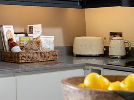 A kitchen with a toaster and kettle on the counter at Church Alley House Stow-On-The-Wold