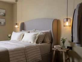A bedroom with a bed and side table at Church Alley House, Stow-On-The-Wold