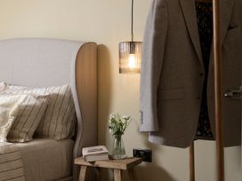 A bedroom with a bed and lamp at Church Alley House, Stow-On-The-Wold
