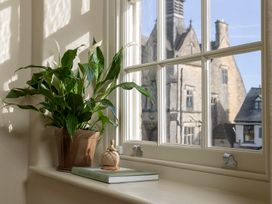 A plant and a book on a windowsill at Church Alley House Stow-On-The-Wold