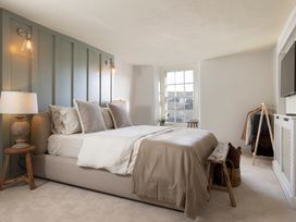 A bedroom with a bed and television at Church Alley House Stow-On-The-Wold