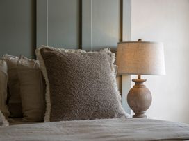 A bedroom with pillows and a lamp at Church Alley House in Stow-On-The-Wold