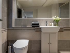 A bathroom with a sink, toilet, and mirror at Church Alley House in Stow-On-The-Wold