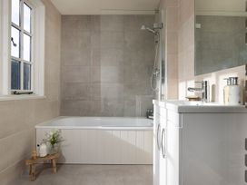 A bathroom featuring a bathtub, shower and sink at Church Alley House in Stow-On-The-Wold