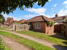 An outdoor view of a brick building with a pathway at The Cook’s Cottage in Malton