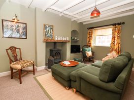 A living room with a sofa and chair at The Cook’s Cottage in Malton