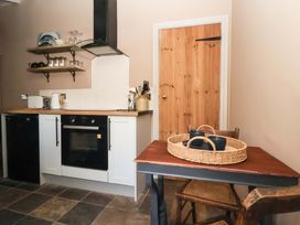 A kitchen with furniture and appliances at The Cook’s Cottage in Malton