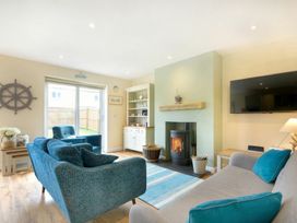 A living room with furniture and a fireplace at Beach Walk in Chathill