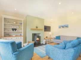 A living room with a fireplace and seating area at Beach Walk in Chathill